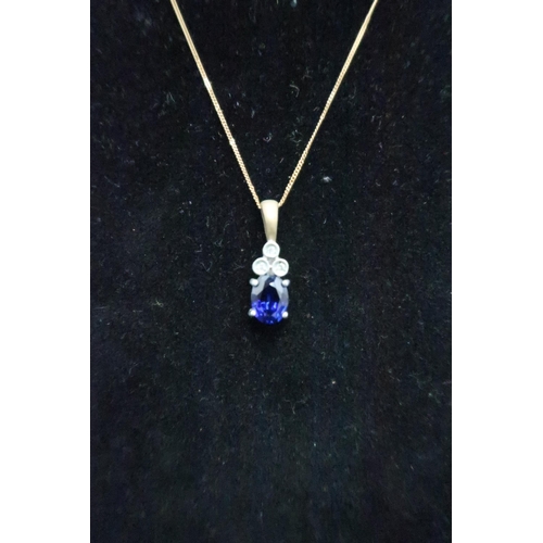 143 - A 9ct gold oval sapphire and trefoil single cut diamond pendant. Weight 2.48 grams