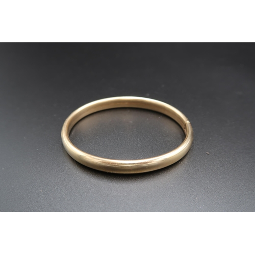 147 - A 9ct gold smooth bangle. Weight 10.98 grams