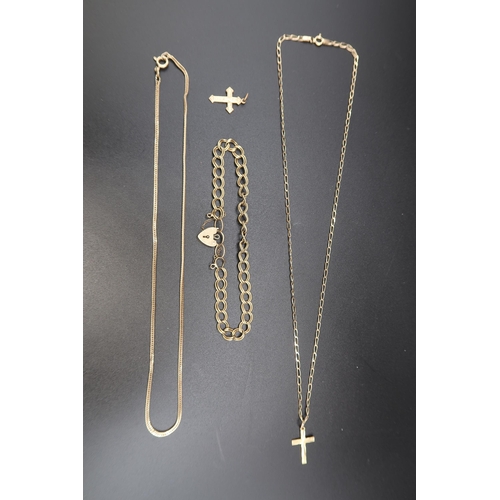 148 - A collection of 9ct gold items to include: a bracelet, two chains and two cross pendants. Weight 14.... 