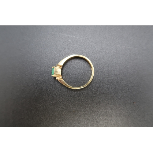 152 - An emerald and diamond three stone ring. The emerald approximately 4.7 by 4.8mm. With a brilliant cu... 