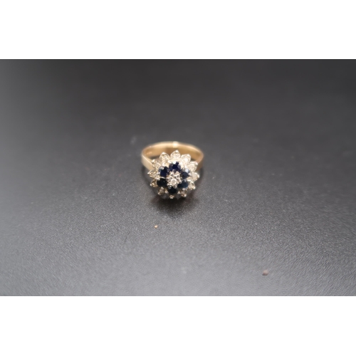 155 - A 9ct gold sapphire and diamond tiered flower cluster ring. Size O. Weight 4.39 grams