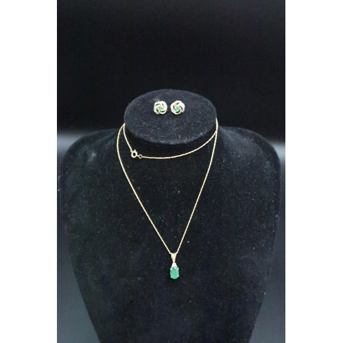 161 - An emerald and diamond pendant and earring set. Stamped 9K. Weight 1.83 grams