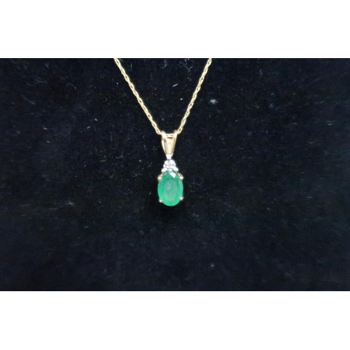 161 - An emerald and diamond pendant and earring set. Stamped 9K. Weight 1.83 grams