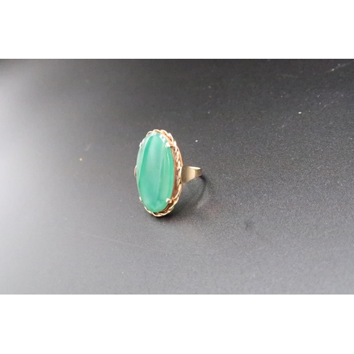 169 - A green stone panel ring. Size O. Stamped 585. Weight 5.21 grams