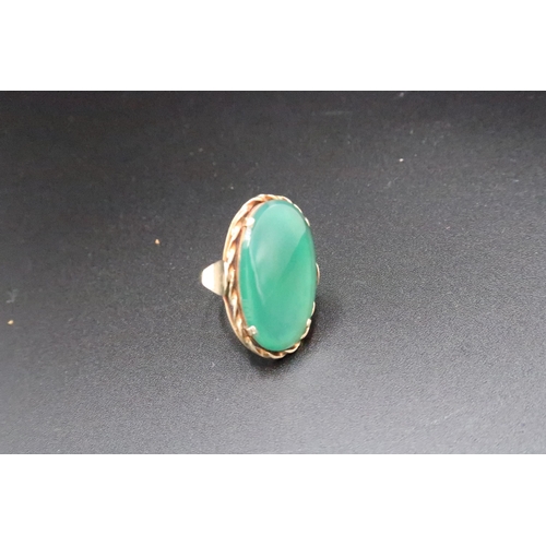 169 - A green stone panel ring. Size O. Stamped 585. Weight 5.21 grams