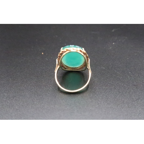 169 - A green stone panel ring. Size O. Stamped 585. Weight 5.21 grams