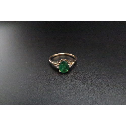 174 - A 9ct gold emerald and white zircon three stone ring. Size O 1/2. Weight 2.05 grams