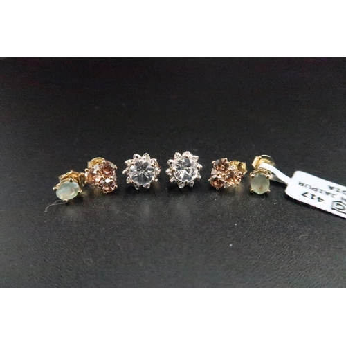 177 - Three pairs of 9ct gold ear studs. To include zircon trefoil clusters with diamond highlights, oval ... 