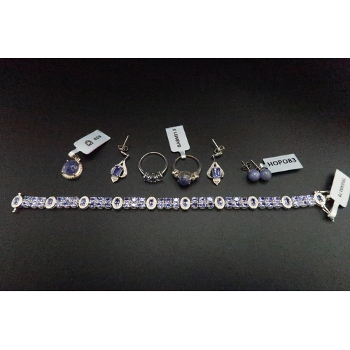 194 - A group of silver tanzanite jewellery. To include a bracelet, two rings, two pairs of earrings and a... 