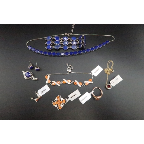 195 - A group of silver jewellery set with mandarin garnet, lapis lazuli and grossular garnet. To include ... 