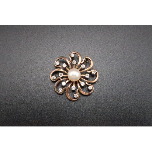 201 - A cultured pearl and brilliant cut diamond openwork flower pendant. Diameter 26mm. Tests gold 18ct. ... 