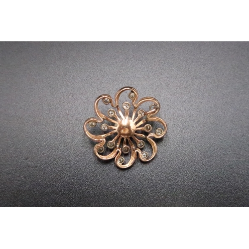 201 - A cultured pearl and brilliant cut diamond openwork flower pendant. Diameter 26mm. Tests gold 18ct. ... 