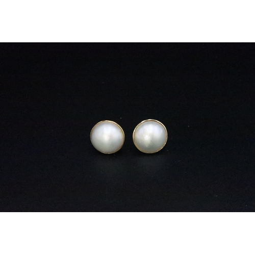 216 - A pair of blister pearl ear studs set in possibly 9ct gold - diameter of pearls approx 14mm