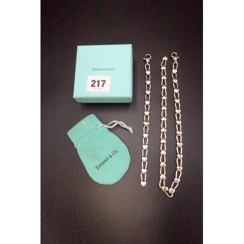 217 - A Tiffany & Co heart padlock link necklace and bracelet suite with gold tone heart to centre of both... 