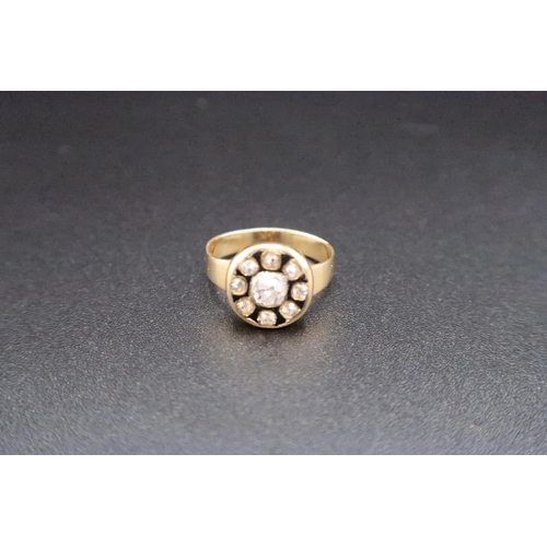 219 - A yellow gold and diamond ring - the central old cut diamond, approx 0.18ct - surrounded by eight ol... 