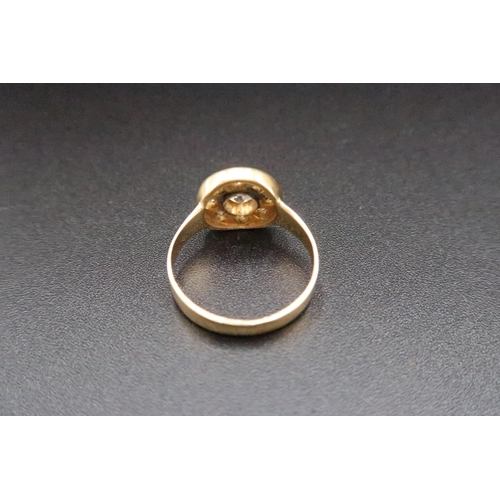 219 - A yellow gold and diamond ring - the central old cut diamond, approx 0.18ct - surrounded by eight ol... 