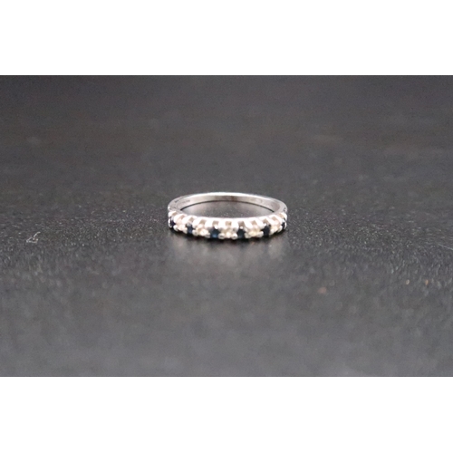 222 - A stamped 9ct white gold eternity ring set with diamonds and sapphires - ring size K - weight approx... 