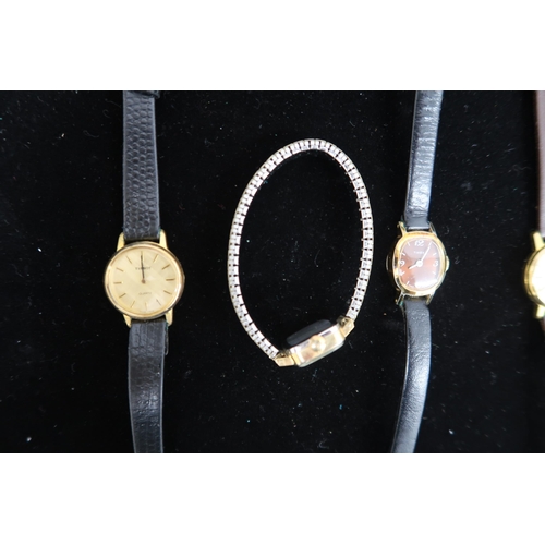 322 - A large group of costume watches including a Philip Mercier quartz example and a Radley watch.