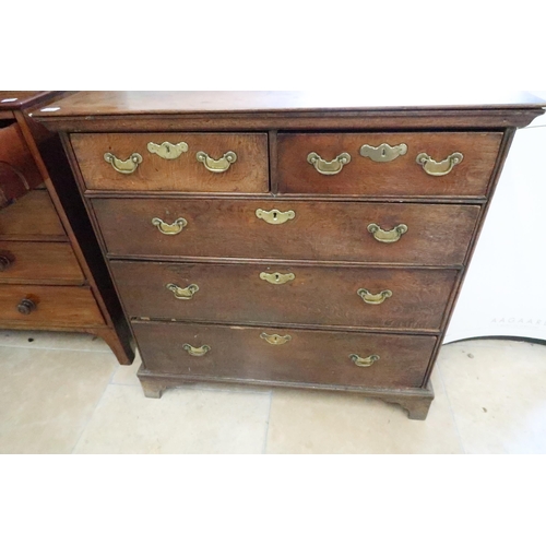 585 - An 18th century elm chest of drawers with brass handles on bracket feet and with oak lined drawers -... 