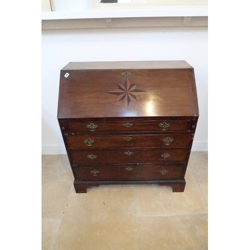 596 - A 19th century oak and mahogany? bureau with an inlaid star fall and fitted interior over four drawe... 