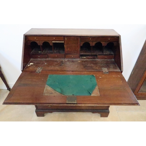 596 - A 19th century oak and mahogany? bureau with an inlaid star fall and fitted interior over four drawe... 