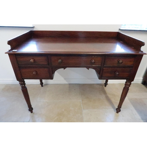 686 - A 19th century mahogany desk with a galleried back over five drawers