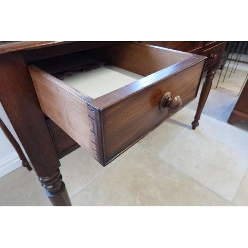 686 - A 19th century mahogany desk with a galleried back over five drawers