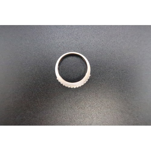 221 - An 18ct white gold (hallmarked) diamond and red stone (believed to be ruby) half eternity ring - the... 