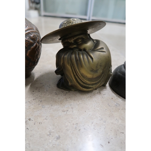  A group of Chinese metal wares, comprising a Buddha figure, curled into his sleeves, sleeping, with ... 