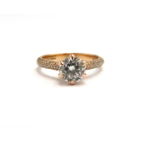  An 18ct gold brilliant cut diamond ring with three rows of diamonds to each shoulder. Accompanied by... 