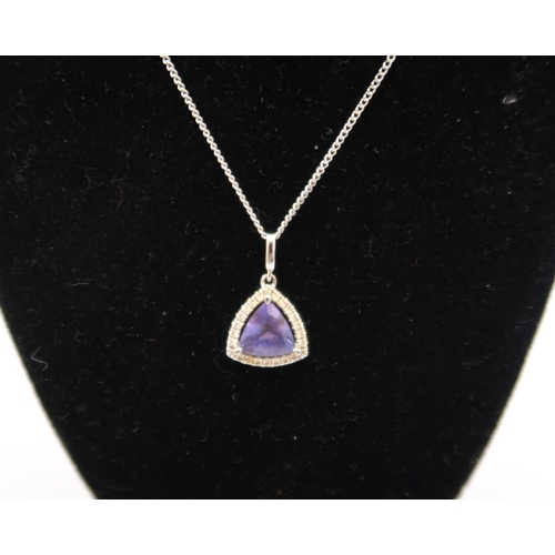  An 18ct white gold triangular Tanzanite and diamond pendant on an 18ct gold chain - approx weight 3.... 