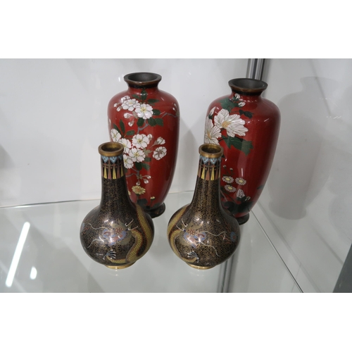  A pair of Chinese cloisonne bottle vases, each with black cloud ground and writhing dragon chasing t... 