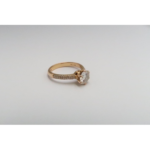  An 18ct gold brilliant cut diamond ring with three rows of diamonds to each shoulder. Accompanied by... 