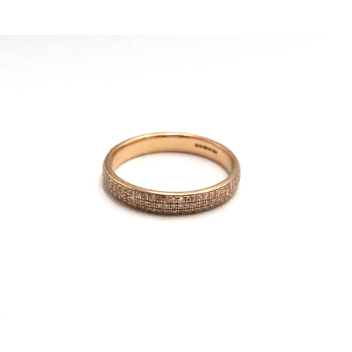  An 18ct gold three row brilliant cut diamond eternity ring. Size M 1/2. Weight 2.58 grams. Estimated... 