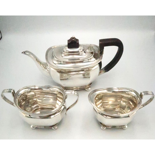 330 - An Art Deco silver tea set, comprising teapot, with ebonised handle and finial, twin handled sugar b... 