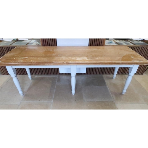 657 - A dining table with painted base and raised on six legs, 247 x 87cm