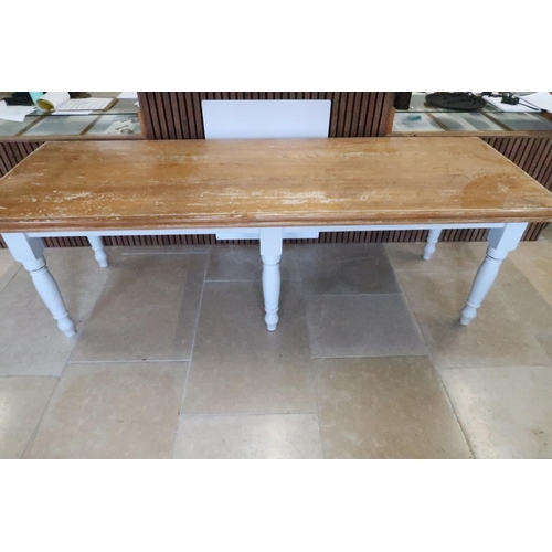 657 - A dining table with painted base and raised on six legs, 247 x 87cm