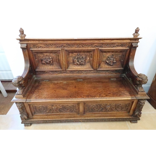 669 - A good 1920's carved oak hall bench with rising seat with storage underneath, good condition for age... 