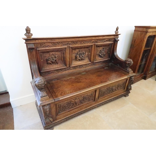 669 - A good 1920's carved oak hall bench with rising seat with storage underneath, good condition for age... 