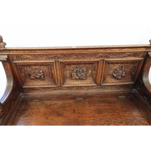 669 - A good 1920's carved oak hall bench with rising seat with storage underneath, good condition for age... 