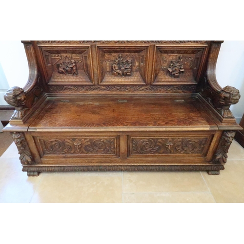 669 - A good 1920's carved oak hall bench with rising seat with storage underneath, good condition for age... 