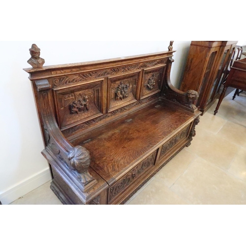 669 - A good 1920's carved oak hall bench with rising seat with storage underneath, good condition for age... 