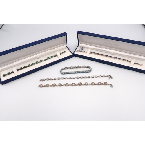 75 - A group of five silver line bracelets, to include emerald, topaz and nilamani together with two furt... 