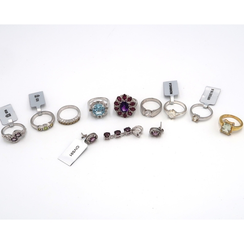 76 - A group of eight silver rings. To include: topaz, an amethyst,  garnet and zircon cluster, Preah Vih... 