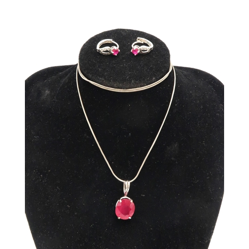 87 - A 9ct white gold and ruby pendant, the oval stone of approximately 11.0 by 12.2mm, likely glass fill... 