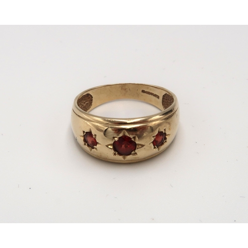 91 - A 9ct gold band ring gypsy set with three garnets. Size S. Weight 4.30 grams