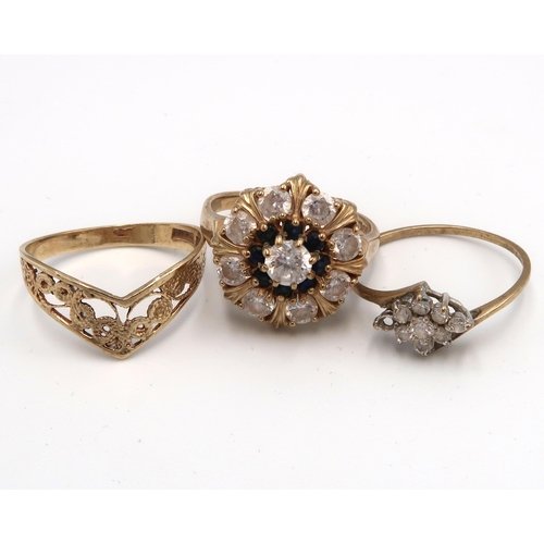 97 - Three 9ct gold rings. To include a wishbone ring size O, a sapphire and white stone cluster size O 1... 