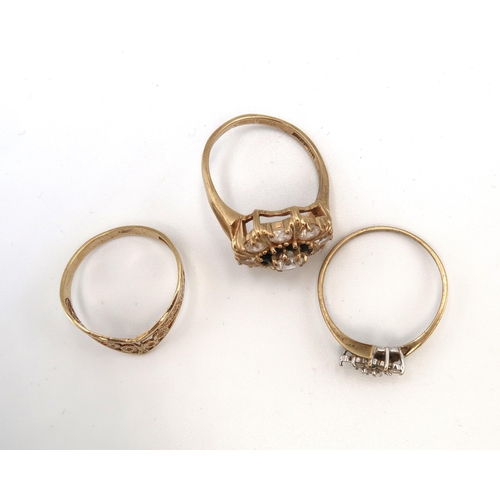 97 - Three 9ct gold rings. To include a wishbone ring size O, a sapphire and white stone cluster size O 1... 