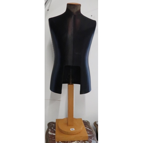 684 - A mid 20th century 'Stockman' London and Paris black silk suit bust on stand, 108cm high x 44cm wide