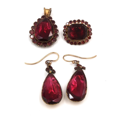 113 - A suite of mid 19th century red stone, likely quartz jewellery, comprising foil backed pendant earri... 